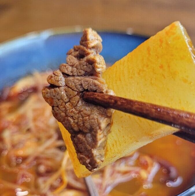 Korean spicy beef soup, yukgaejang, in a bowl with rice