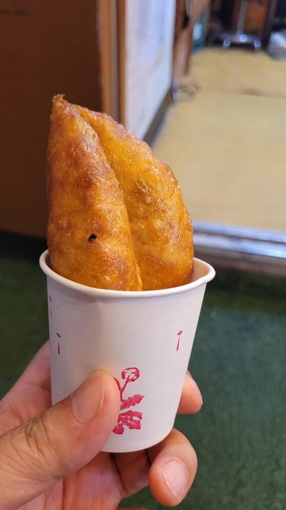 Korean hotteok served folded in a paper cup