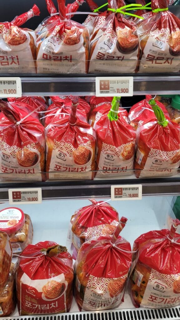 Store-bought kimchi on a Korean supermarket shelf, Bibigo and Jongga brands
