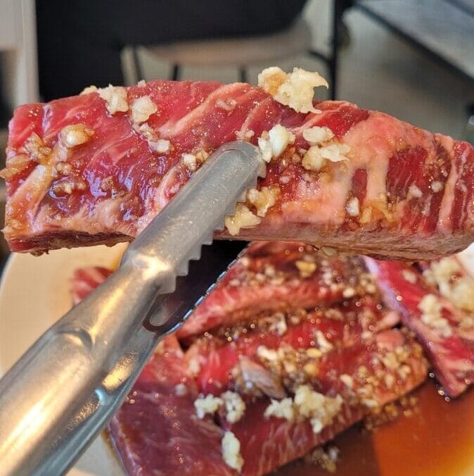 Korean BBQ lunch special galbi grilling over live charcoal at Surae Galbi in Seoul