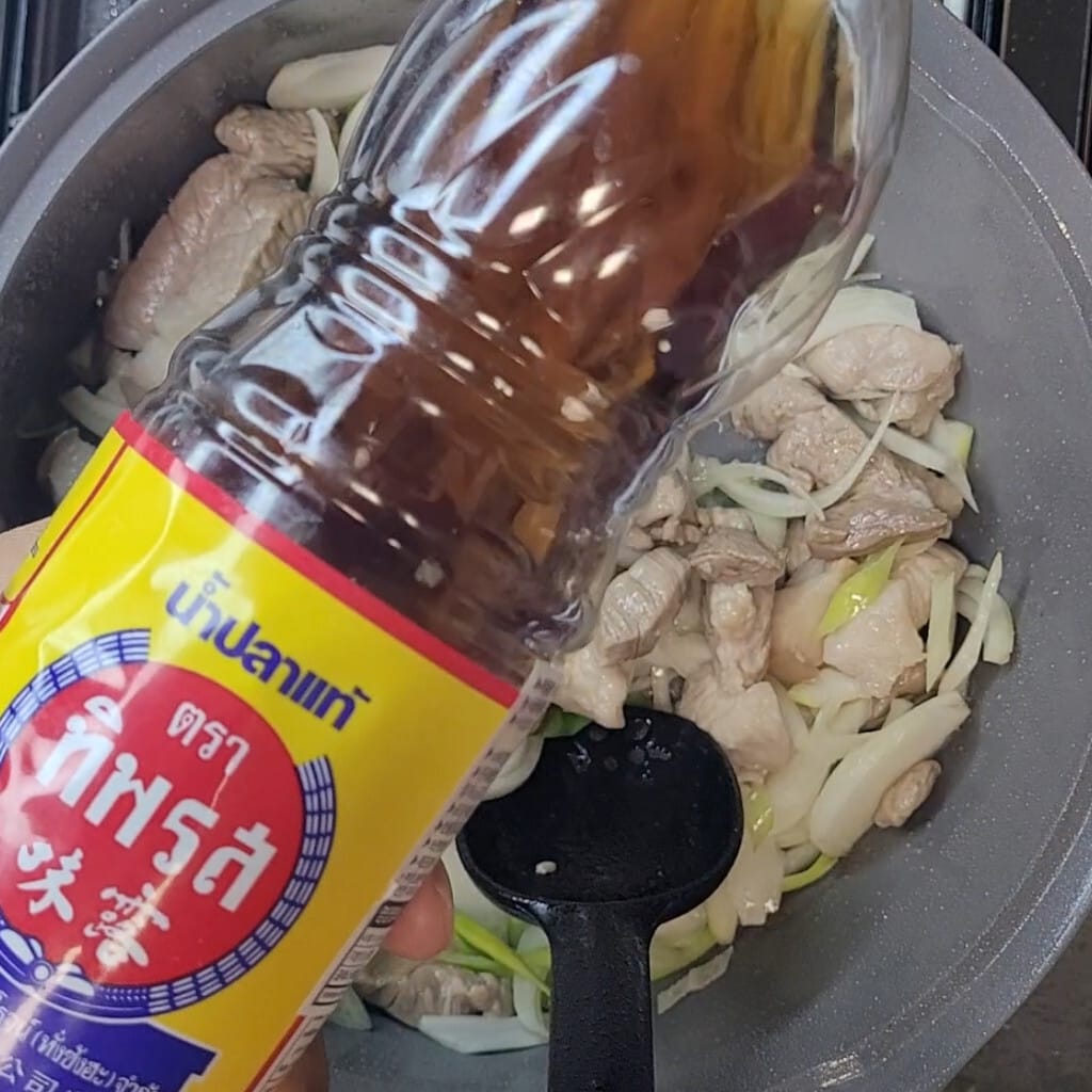Fish sauce going into the pork for kimchi jjigae