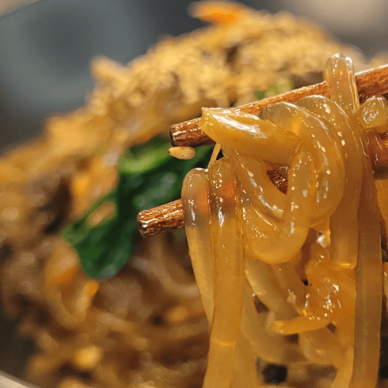 One-pan japchae with glass noodles, pork and vegetables on a plate