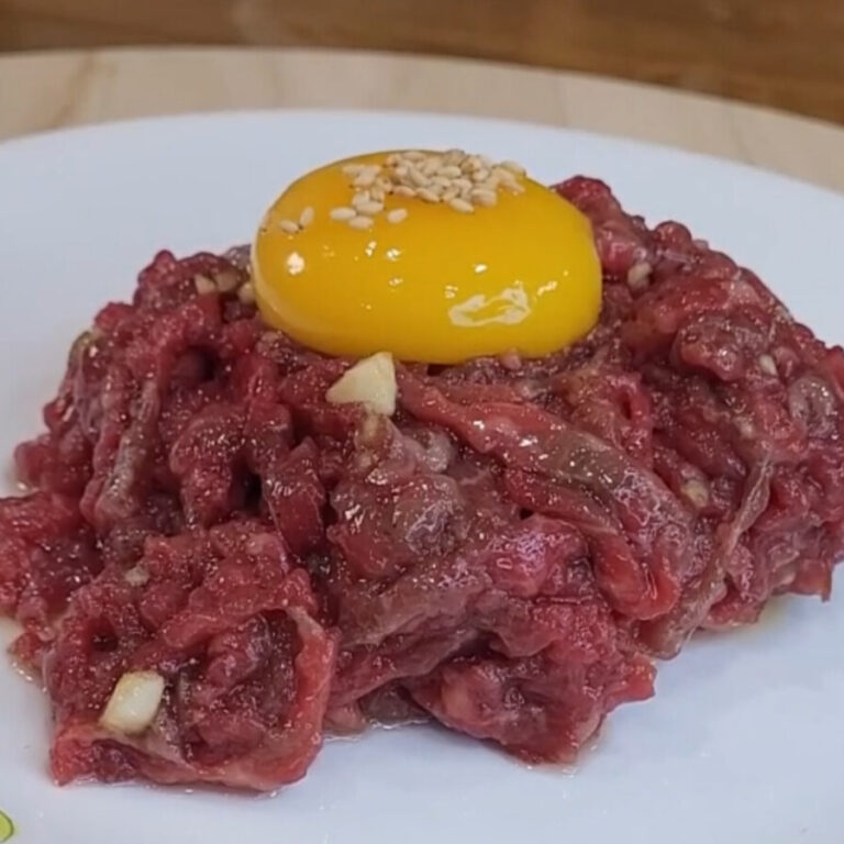 Yukhoe, Korean raw beef strips topped with an egg yolk and sesame seeds