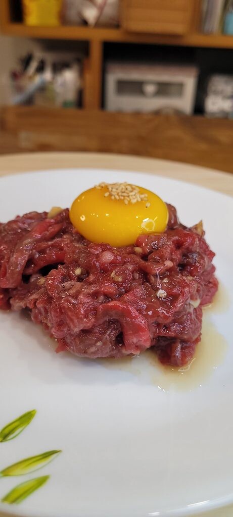 Yukhoe recipe: Korean raw beef strips topped with an egg yolk and sesame seeds