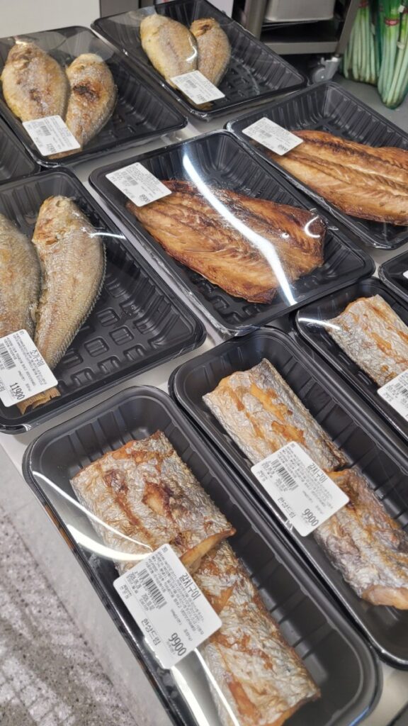 Already grilled mackerel and flatfish boxed at a Korean supermarket