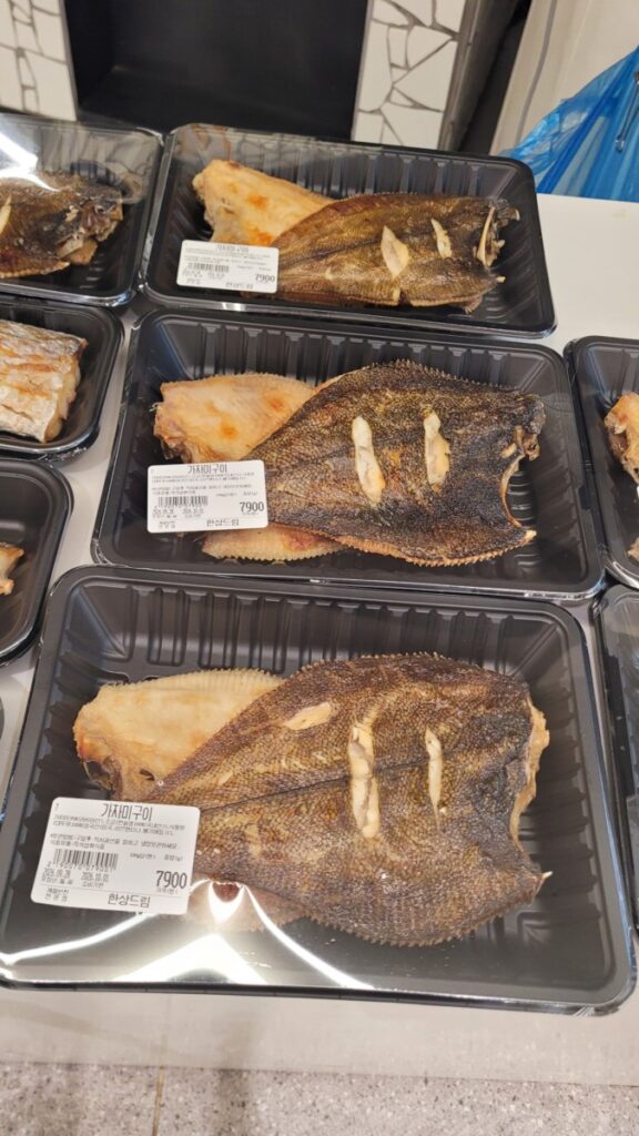 Already grilled mackerel and flatfish boxed at a Korean supermarket