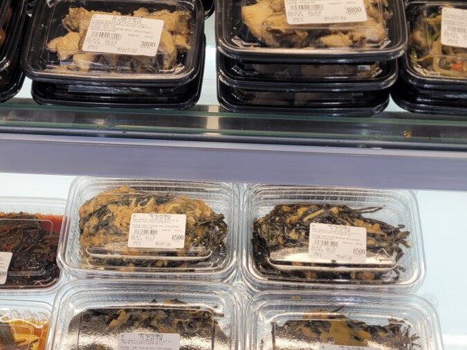 Small banchan trays at a Korean supermarket, priced individually