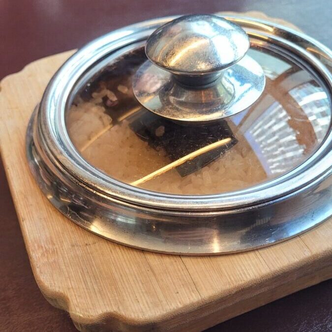Sotbap in a small cast-iron pot with kelp on the rice, at a restaurant in Sangam, Seoul