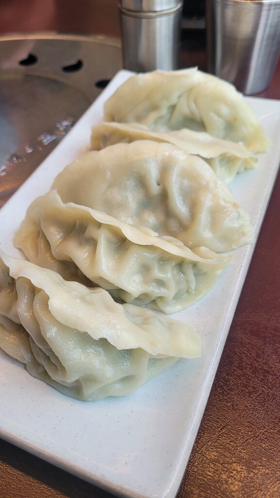 Chive and tofu dumplings with a green filling, served free for groups of four